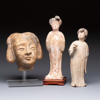 Two Chinese polychrome pottery figures and a female head, Tang