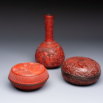 Two Chinese cinnabar lacquer covered boxes and a bottle vase, 19th C.