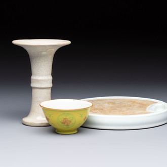 A Chinese Ge-ware archaistic 'Gu' vase, a white-glazed anhua-decorated ink stone and a yellow-ground bowl, 20th C.