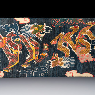 A Tibetan woollen ‘Dragons Chasing the Flaming Pearl’ carpet, 19th C.