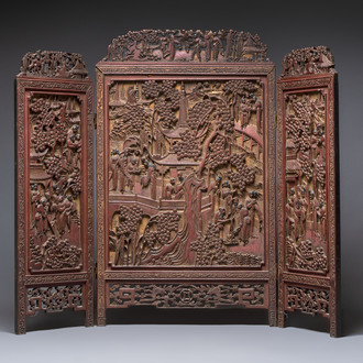 A Chinese carved gilt-lacquered wooden three-panel folding screen with a narrative design, 19/20th C.
