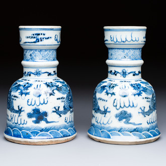 A pair of Chinese blue and white 'Dragons Chasing the Flaming Pearl’ candlesticks, 19th C.