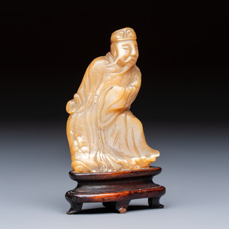A Chinese carved mother-of-pearl figure of an official on wooden stand, 18/19th C.
