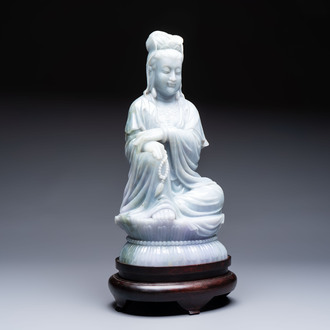 An exceptional and large Chinese carved pale lavender jadeite Guanyin on a wooden stand, Republic