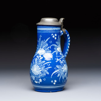 A Nevers white-decorated Persian-blue-ground faience jug with a mounted pewter lid, France, 18th C.