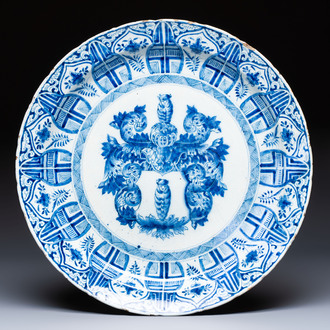 A large blue and white Dutch Delft armorial dish, 18th C.