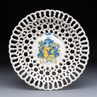 A polychrome Italian maiolica armorial reticulated basket, workshop of Virgiliotto Calamelli, Faenza, 16th C.