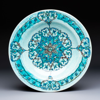 A polychrome Kuthaya pottery Iznik-style turquoise-ground dish, 19th C.