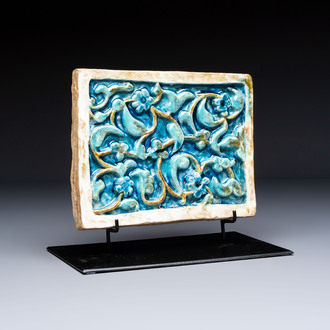 A Timurid polychrome-glazed rectangular tile with foliage design, on a later metal stand, Central Asia, 14th C.