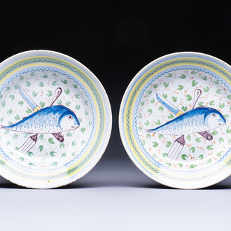 A pair of unusual polychrome Brussels faience plates with fish and cutlery, 18th C.
