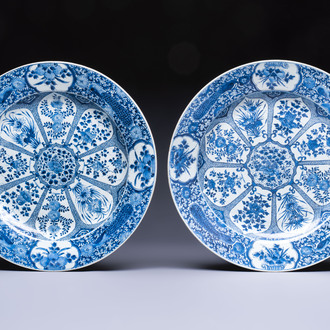 A pair of large Chinese blue and white 'Peacock Border' chargers with floral design, Kangxi