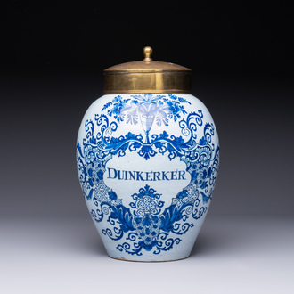 A blue and white Dutch Delft tobacco jar inscribed 'Duinkerker' with brass lid, 18th C.