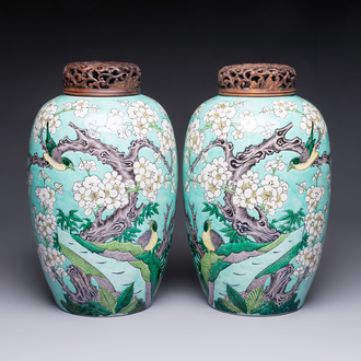 A pair of fine Chinese famille verte turquoise-ground 'Magpie and Prunus' jars with reticulated wooden covers, 19th C.