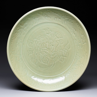 A rare and large Chinese Longquan celadon dish with floral design, Ming, early 15th C.