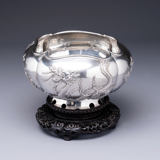 A fine Chinese silver bowl with relief dragon design on reticulated wooden stand, Tai Chang Long 泰昌隆 mark, 19th C.