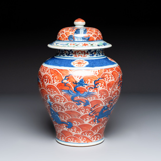 A Chinese blue, white and iron-red decorated 'Mythical Animals' vase and cover, 19th C.