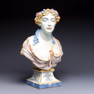 A large polychrome French faience monogrammed bust of a woman emblematic of spring, probably Rouen, early 19th C.