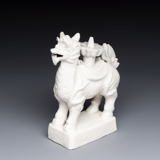 A Chinese Dehua blanc de Chine candlestick in the form a qilin, Kangxi