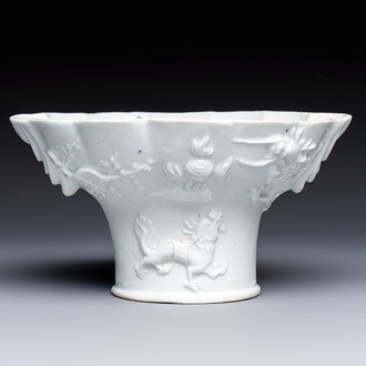 A very large Chinese Dehua blanc de Chine libation cup with a dragon, a qilin, a tiger and a crane, 18th C.
