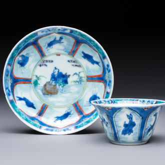 A Chinese European-decorated blue and white 'Fisherman' cup and saucer, Kangxi