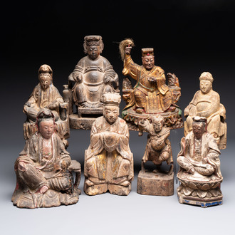 Eight Chinese carved wooden sculptures with traces of polychromy and gilding, 19th C.