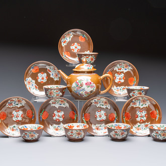 A Chinese famille rose capucine-ground covered teapot with floral design, seven cups and saucers, Yongzheng/Qianlong