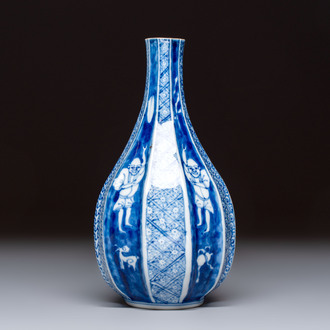 A Japanese blue and white sake bottle with figural design, Meiji, 19th C.