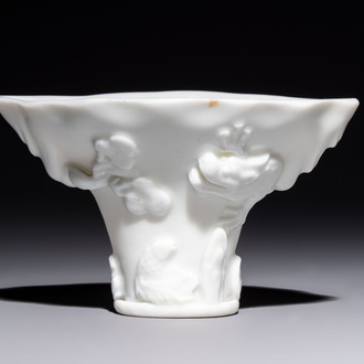 A Chinese Dehua blanc de Chine 'Dragon, Carp, Crane and Deer' libation cup, Kangxi