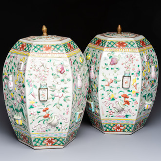 A pair of Chinese famille rose 'Antiquities' vases and covers, 19th C.