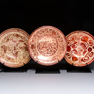 Three Hispano-Moresque lustre-ware plates on later metal stands, Spain, 17/18th C.