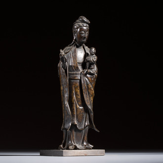 A Chinese bronze standing Guanyin with boy, Ming