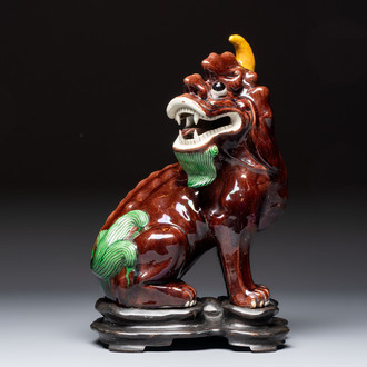 A Chinese sancai-glazed Xiezhi on a wooden stand, 19th C.
