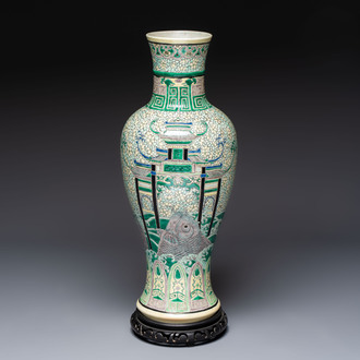 A Chinese verte biscuit 'Dragon Gate Carp 鯉躍龍門' vase on a wooden stand, Xuande mark, 19th C.
