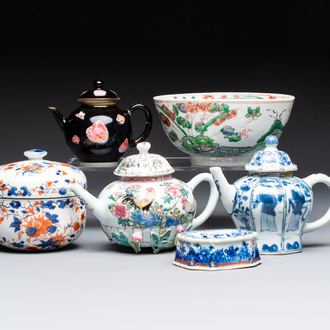 Three Chinese blue and white, famille rose and black-glazed covered teapots, a salt, an Imari-style covered bowl, and a famille verte bowl, 18th C.