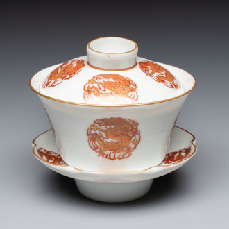 A fine Chinese iron-red gilt-decorated covered teabowl with a stand, Guangxu mark and of the period
