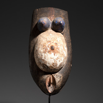 A polychromed wooden fertility belly mask from the Yoruba people, West Africa, 20th C.