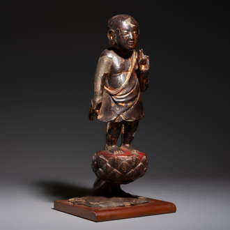 A rare Chinese gilt-lacquered bronze Buddha standing on a lotus throne, Ming