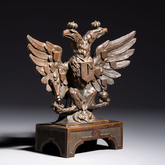 A bronze imperial Russian double-headed eagle coat of arms, mounted as a pocket watch holder, 19/20th C.