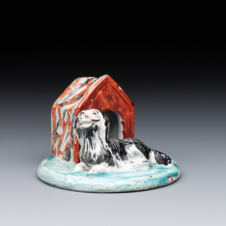 A rare polychrome Dutch Delft petit feu sculpture of a dog in front of its kennel, 18th C.
