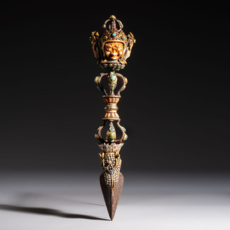 A Tibetan parcel-gilt silver and iron phurba inlaid with precious stones, red coral and bone, 19th C.