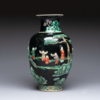 An unusual Chinese famille noire vase with relief design, Kangxi mark, 19th C.