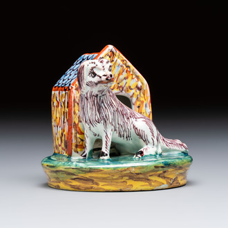 A rare polychrome Dutch Delft sculpture of a dog in front of its kennel, 18th C.