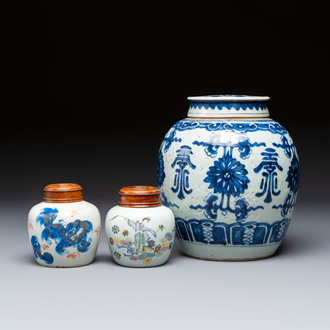 A Chinese blue and white covered jar and two polychrome-decorated jarlets with wooden covers, 18/19th C.