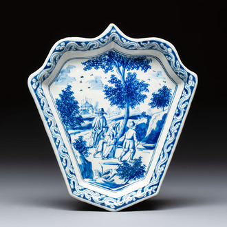 A fine blue and white Dutch Delft leaf-shaped dish with travellers in a landscape, early 18th C.