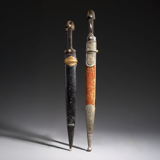 Two Caucasian Kindjal daggers with horn hilts, one with a gilt-iron-mounted leather scabbard and one with a metal-mounted velvet scabbard, 18/19th C