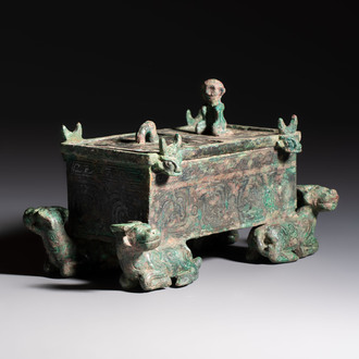 A Chinese archaic bronze cosmetic box standing on four stylised buffalo-form feet, Lian 奩, Eastern Zhou/Spring and Autumn