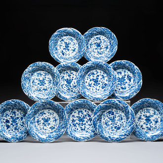 Eleven Chinese blue and white gadrooned 'Flowers and Peacocks' plates, Kangxi