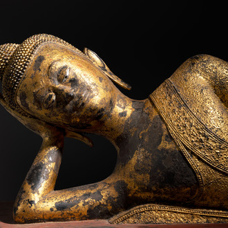 An exceptional and large Thai gilt-bronze figure of Buddha in Parinirvana, 18th C.