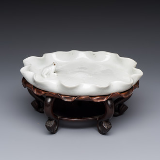A Chinese Dehua blanc de Chine 'Lotus Leaf and Frog' brush washer on a wooden stand, Kangxi/Yongzheng
