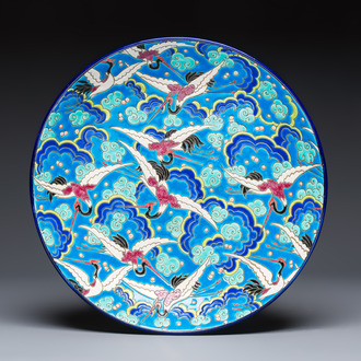 A French polychrome enamelled Longwy 'Cranes among Clouds' charger, 20th C.